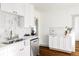 Modern kitchen with white cabinets, quartz countertops, and a subway tile backsplash at 4659 Wyandot St, Denver, CO 80211