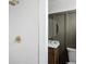 White tile shower with gold fixtures and a view of the vanity at 4659 Wyandot St, Denver, CO 80211