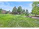 A view of the home and backyard landscaping at 8518 High Ridge, Castle Pines, CO 80108