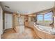 Luxurious bathroom featuring a glass shower, double vanity, and a large soaking tub with scenic views at 8518 High Ridge, Castle Pines, CO 80108