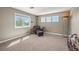 Bedroom featuring comfortable seating, plush carpeting, and natural light from large windows at 8518 High Ridge, Castle Pines, CO 80108