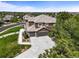 Aerial view of the home showcasing the landscaping, driveway and three-car garage at 8518 High Ridge, Castle Pines, CO 80108