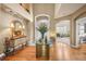 Bright foyer with gleaming hardwood floors, high ceilings, elegant furnishings, and an inviting ambiance at 8518 High Ridge, Castle Pines, CO 80108