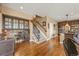 Inviting hallway featuring hardwood floors and carpeted stairs with wrought iron railing at 8518 High Ridge, Castle Pines, CO 80108
