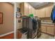 Modern laundry room featuring front-loading washer and dryer and plenty of storage at 8518 High Ridge, Castle Pines, CO 80108