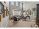 Elegant living room boasting high ceilings, large windows, plush seating, and sophisticated decor at 8518 High Ridge, Castle Pines, CO 80108