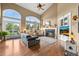 Bright living room featuring hardwood floors, fireplace, and scenic backyard views at 8518 High Ridge, Castle Pines, CO 80108