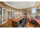 Cozy office space with custom desk, wood floors, and large windows for natural light at 8518 High Ridge, Castle Pines, CO 80108