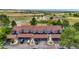 Aerial view of townhouses with attached garages and surrounding landscape at 6539 Pinewood Dr # 57, Parker, CO 80134