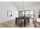 Bright dining room with natural light, contemporary chandelier, and hardwood floors overlooking a covered patio at 6539 Pinewood Dr # 57, Parker, CO 80134