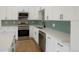 Modern kitchen with stainless steel appliances and green tile backsplash at 6539 Pinewood Dr # 57, Parker, CO 80134