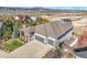 A high angle of this home with its 3 car garage, neutral paint color, and landscaping at 16088 Denver Pacific Dr, Monument, CO 80132