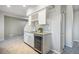 Basement bar features granite counters, white cabinets, wine rack, and beverage cooler at 16088 Denver Pacific Dr, Monument, CO 80132
