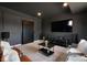 Finished basement features a large tv, gray paint, a modern entertainment system and neutral carpet at 16088 Denver Pacific Dr, Monument, CO 80132