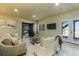 Basement with comfortable seating, a large-screen television, and patio doors to the outside at 16088 Denver Pacific Dr, Monument, CO 80132