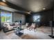 Finished basement has a sofa, and treadmill near gray walls, black trim and recessed lighting at 16088 Denver Pacific Dr, Monument, CO 80132