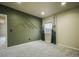 Bedroom with accent wall, neutral carpet, and stylish window treatments at 16088 Denver Pacific Dr, Monument, CO 80132