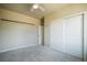 This bedroom features a ceiling fan, neutral walls, and a large closet at 16088 Denver Pacific Dr, Monument, CO 80132