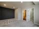 Bedroom with gray accent wall leading to an en suite bathroom and a walk-in closet at 16088 Denver Pacific Dr, Monument, CO 80132