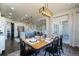 Open concept dining room with stylish light fixture, hardwood floors, and easy access to the kitchen and deck at 16088 Denver Pacific Dr, Monument, CO 80132