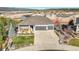 Lovely home featuring a well-manicured lawn, 3-car garage, and a charming front porch at 16088 Denver Pacific Dr, Monument, CO 80132
