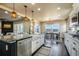 Open-concept kitchen with granite counters, stainless steel appliances, and seamless dining area views at 16088 Denver Pacific Dr, Monument, CO 80132