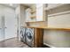 Convenient laundry room with butcher block countertop, shelving, and modern washer and dryer at 16088 Denver Pacific Dr, Monument, CO 80132