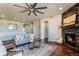 Cozy living room with stone fireplace, stylish furniture, and an archway leading to other rooms at 16088 Denver Pacific Dr, Monument, CO 80132