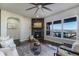Comfortable living room with stone fireplace and large windows offering stunning views at 16088 Denver Pacific Dr, Monument, CO 80132