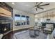 Bright living room with a fireplace that is open to the kitchen area, creating a sociable space at 16088 Denver Pacific Dr, Monument, CO 80132