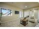Bright living area with large windows, neutral paint, and comfortable seating near the glass patio doors at 16088 Denver Pacific Dr, Monument, CO 80132