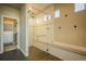 Bathroom featuring a glass shower, tiled walls, a bench, and access to a walk-in closet at 16088 Denver Pacific Dr, Monument, CO 80132