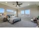 Spacious main bedroom with a tray ceiling, mountain views, and a cozy sitting area by the window at 16088 Denver Pacific Dr, Monument, CO 80132