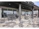 Relaxing back porch with stone flooring, hanging swing chairs, and outdoor dining set for outdoor entertaining at 3564 Doubletrack Ln, Castle Rock, CO 80108