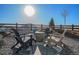 Backyard featuring an outdoor fire pit, stone patio, and Adirondack chairs for outdoor relaxing at 3564 Doubletrack Ln, Castle Rock, CO 80108