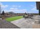 Backyard featuring an outdoor fire pit, stone patio, and a wooden fence enclosing the perimeter at 3564 Doubletrack Ln, Castle Rock, CO 80108