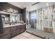 The renovated bathroom features a large walk-in shower with a glass enclosure and a modern vanity with sleek fixtures at 3564 Doubletrack Ln, Castle Rock, CO 80108