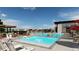 Community pool featuring multiple pools, lounge chairs, umbrellas, and a modern clubhouse at 3564 Doubletrack Ln, Castle Rock, CO 80108