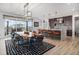 Stylish dining area with a modern table, chairs, and an open view to the sleek kitchen at 3564 Doubletrack Ln, Castle Rock, CO 80108
