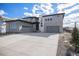 Beautiful two-story home with gray siding, stone accents, a spacious driveway, and a two-car garage at 3564 Doubletrack Ln, Castle Rock, CO 80108
