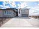 Stunning exterior showcasing a two-story home with a well-manicured yard and gray tones at 3564 Doubletrack Ln, Castle Rock, CO 80108