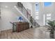 Inviting foyer with a modern staircase, stylish decor, wood floors and abundant natural light at 3564 Doubletrack Ln, Castle Rock, CO 80108