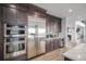 Kitchen area features stainless steel appliances, dark cabinetry, and open layout for modern living at 3564 Doubletrack Ln, Castle Rock, CO 80108
