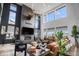 Elegant living room with a fireplace, soaring ceilings, large windows and a comfortable leather sofa at 3564 Doubletrack Ln, Castle Rock, CO 80108