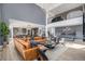 Open-concept living room with high ceilings, a large sofa, and seamless flow to the kitchen at 3564 Doubletrack Ln, Castle Rock, CO 80108