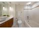 Clean bathroom featuring white tiled walls, modern wood vanity, and integrated bathtub and shower at 1020 15Th St # 42A, Denver, CO 80202