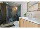 Bathroom featuring walk-in shower with glass door, modern vanity, and patterned mirror at 1020 15Th St # 42A, Denver, CO 80202