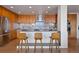 Modern kitchen with stainless steel appliances, wooden cabinets, and a breakfast bar at 1020 15Th St # 42A, Denver, CO 80202