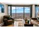 Cozy living room with plush leather seating, expansive windows, and scenic city views at 1020 15Th St # 42A, Denver, CO 80202