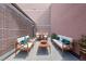 Private patio with modern outdoor seating and dining area surrounded by brick walls at 1020 15Th St # 42A, Denver, CO 80202